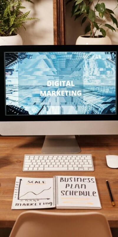 Contemporary office setup featuring digital marketing strategy on a computer screen, ideal for business technology themes.