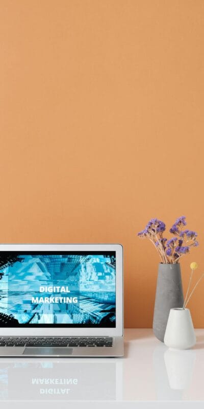 Modern workspace with laptop and decorative flowers showcasing digital marketing.